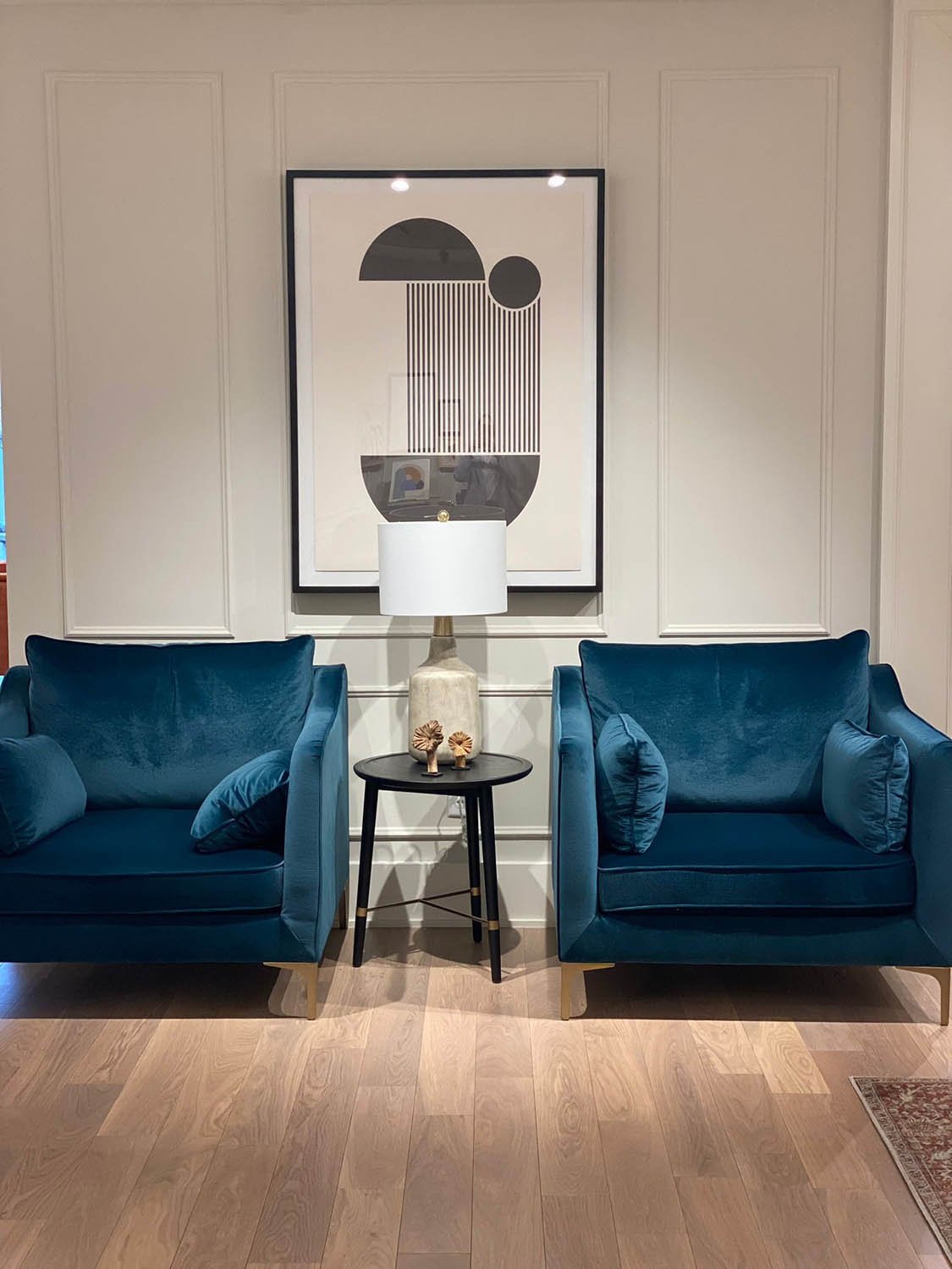 Pair of blue velvet armchairs and framed art staged in a Dallas-Fort Worth home by Eleven 11 Home Staging