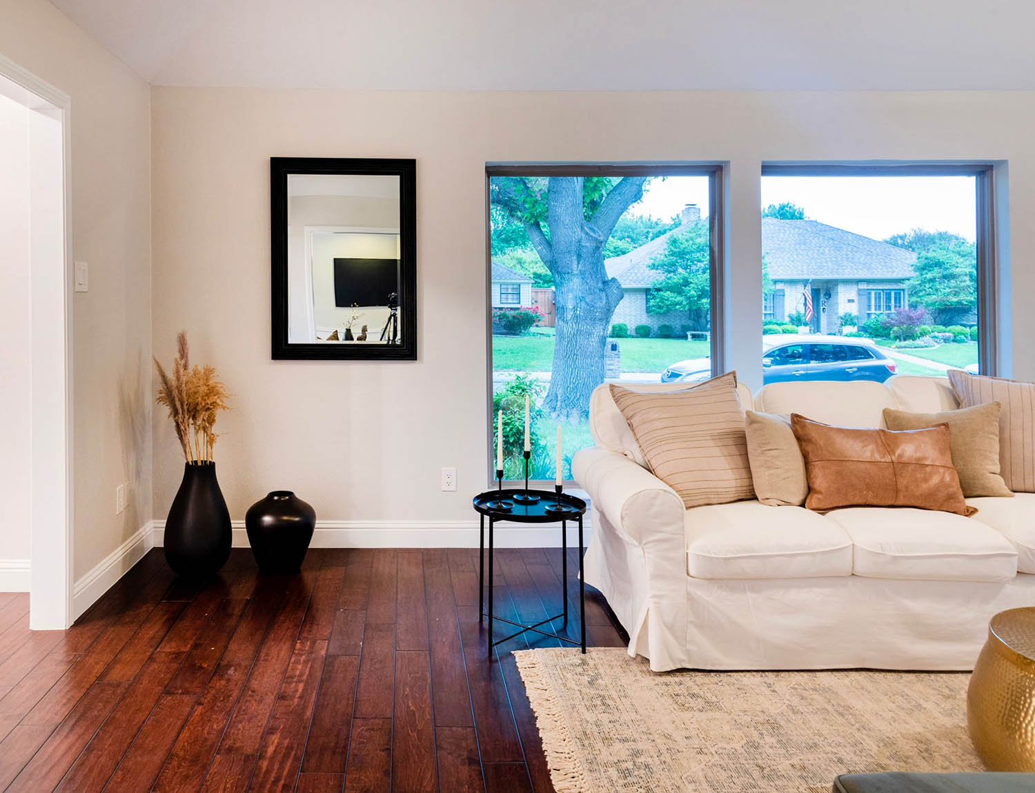 Staged DFW living room with slipcovered sofa, antique rug, and fireplace styled by Eleven 11 Home Staging